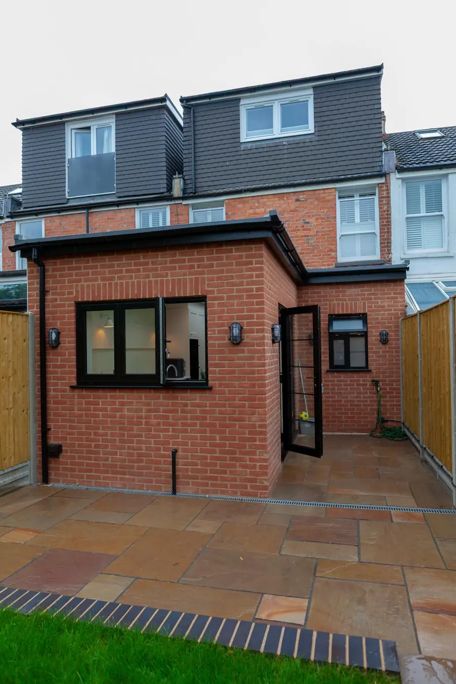 Brick single-storey rear extension below a dormer loft conversion